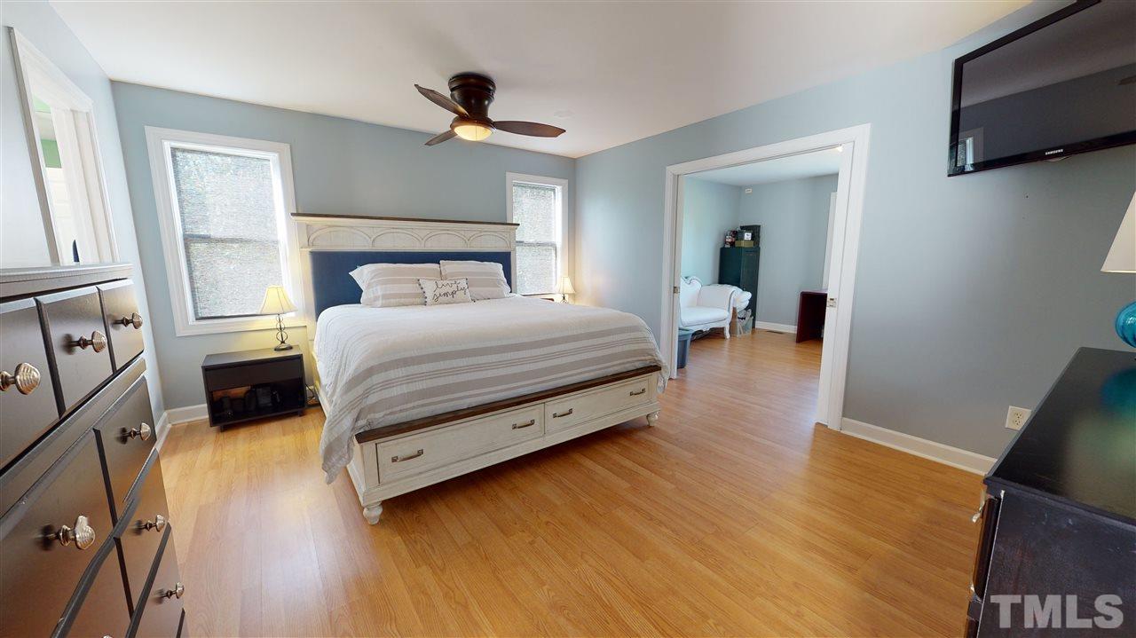 6558 Todd Road Bailey, NC 27807 - Photo 15 of 23 a bedroom with a bed and flat tv screen on dresser