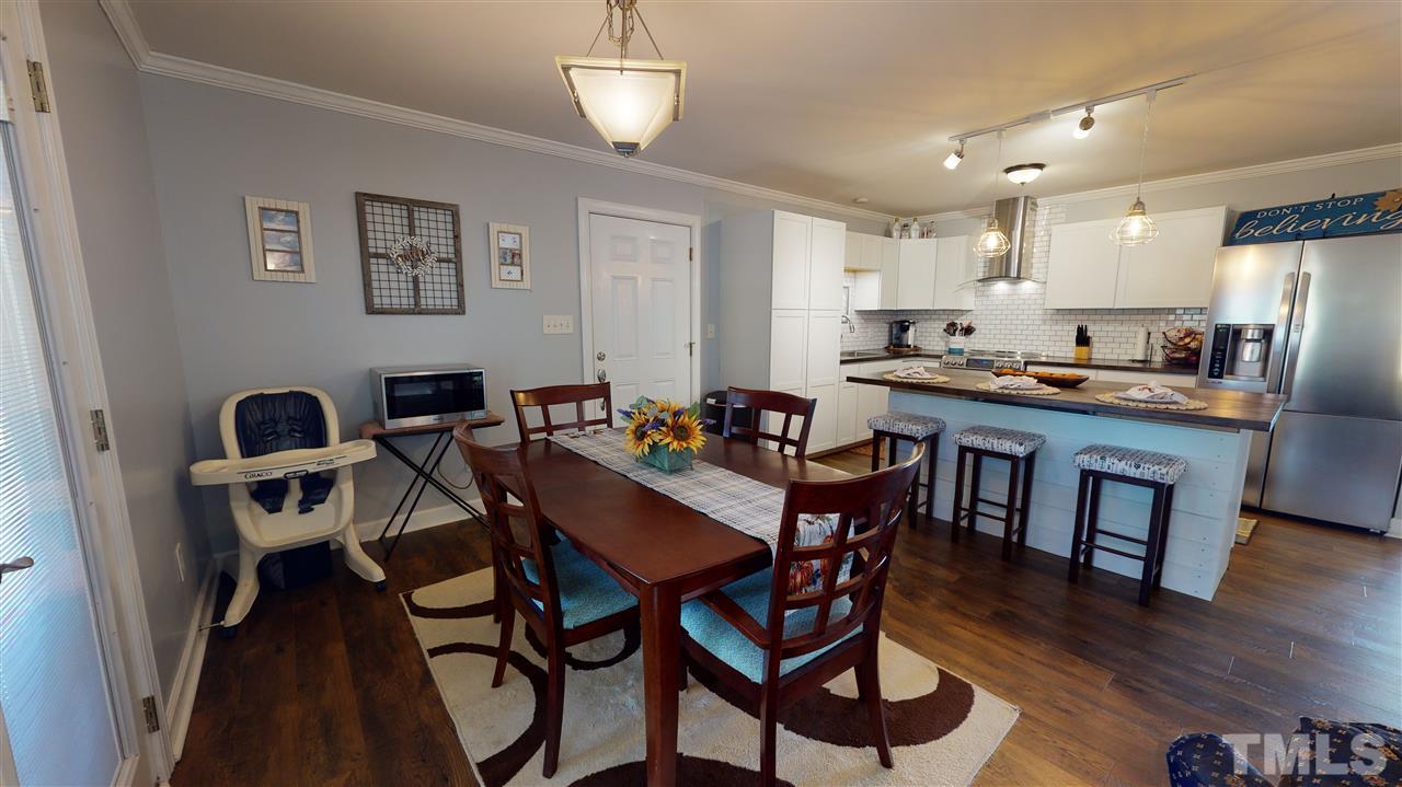 6558 Todd Road Bailey, NC 27807 - Photo 8 of 23 a view of a dining room with furniture and wooden floor