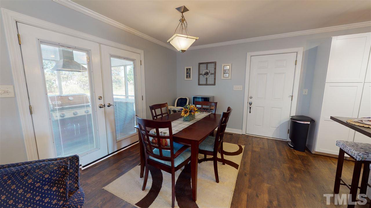 6558 Todd Road Bailey, NC 27807 - Photo 9 of 23 a view of a dining room with furniture and wooden floor