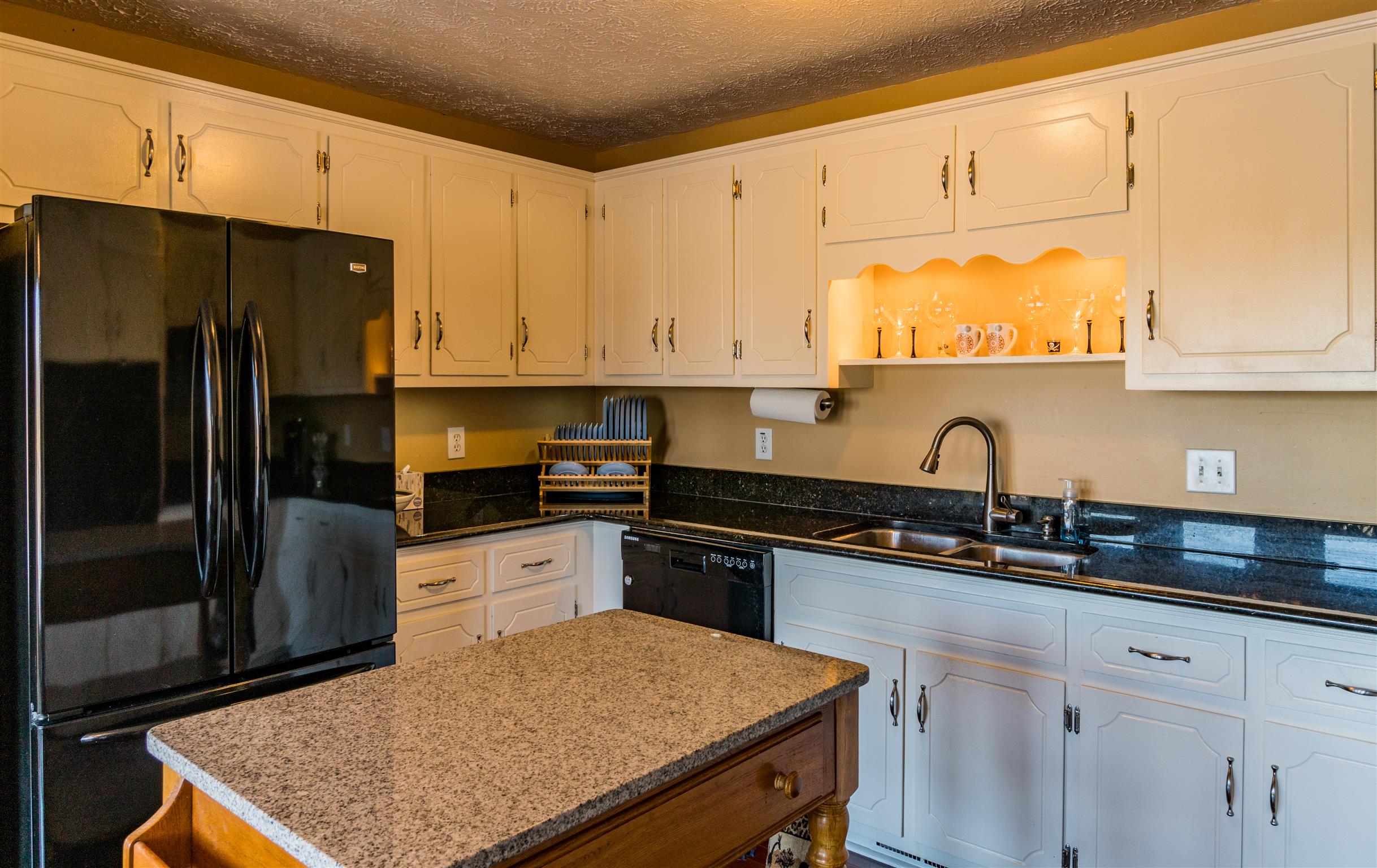 291 Mayhew Road Clarksville, TN 37040 - Photo 13 of 30 a kitchen with granite countertop a sink stove and refrigerator