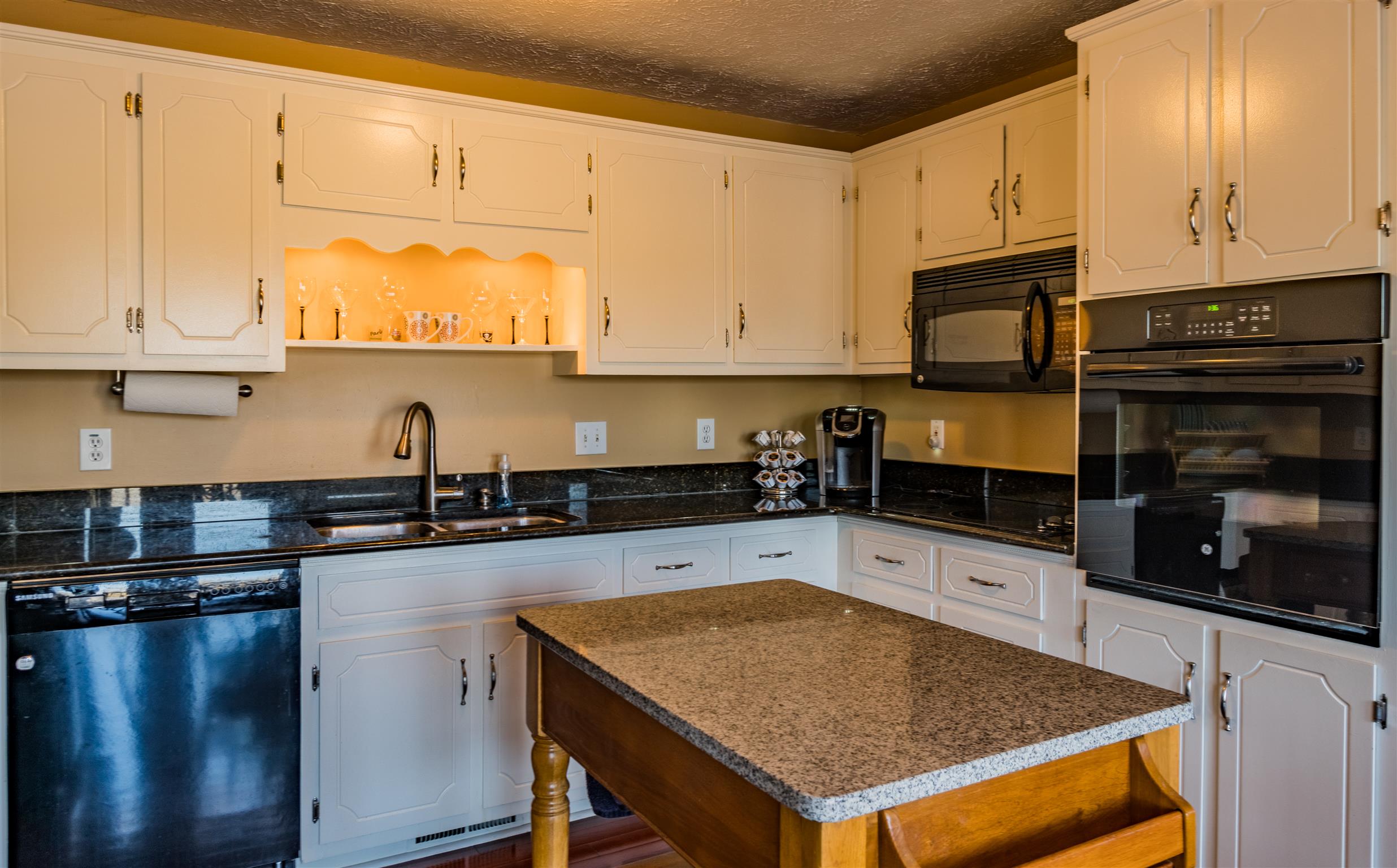 291 Mayhew Road Clarksville, TN 37040 - Photo 14 of 30 a kitchen with stainless steel appliances granite countertop a stove sink and cabinets