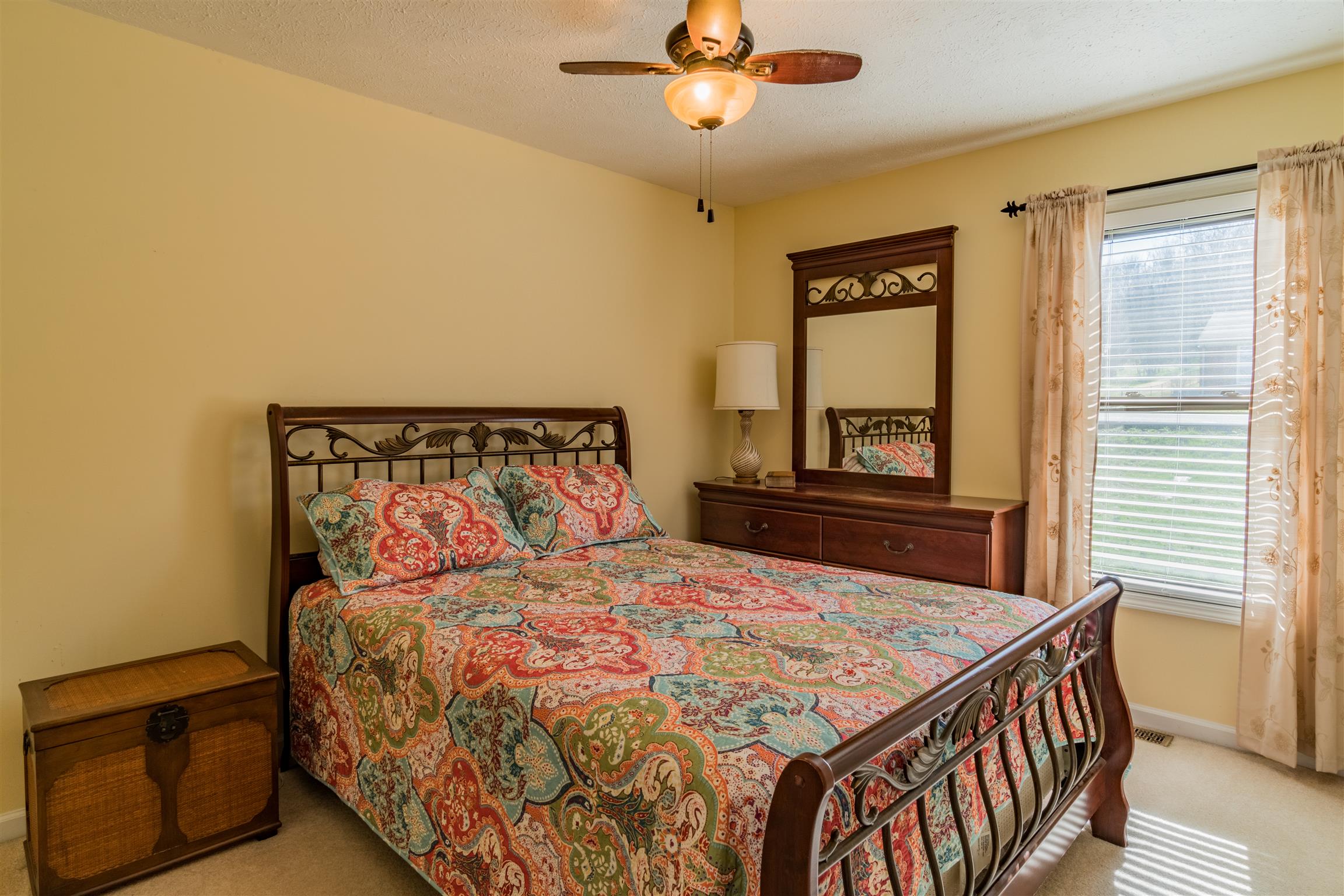 291 Mayhew Road Clarksville, TN 37040 - Photo 23 of 30 a bedroom with a bed and a chandelier