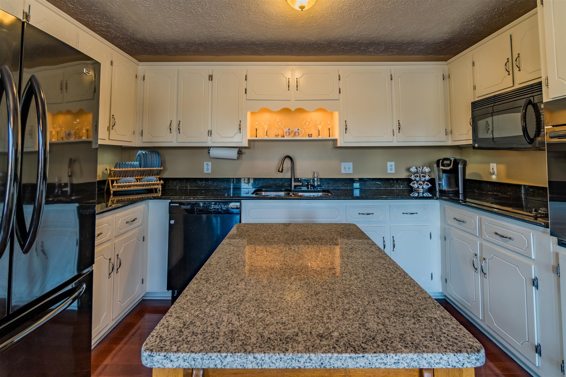 291 Mayhew Road Clarksville, TN 37040 - Photo 24 of 30 a kitchen with kitchen island granite countertop a sink stainless steel appliances and cabinets