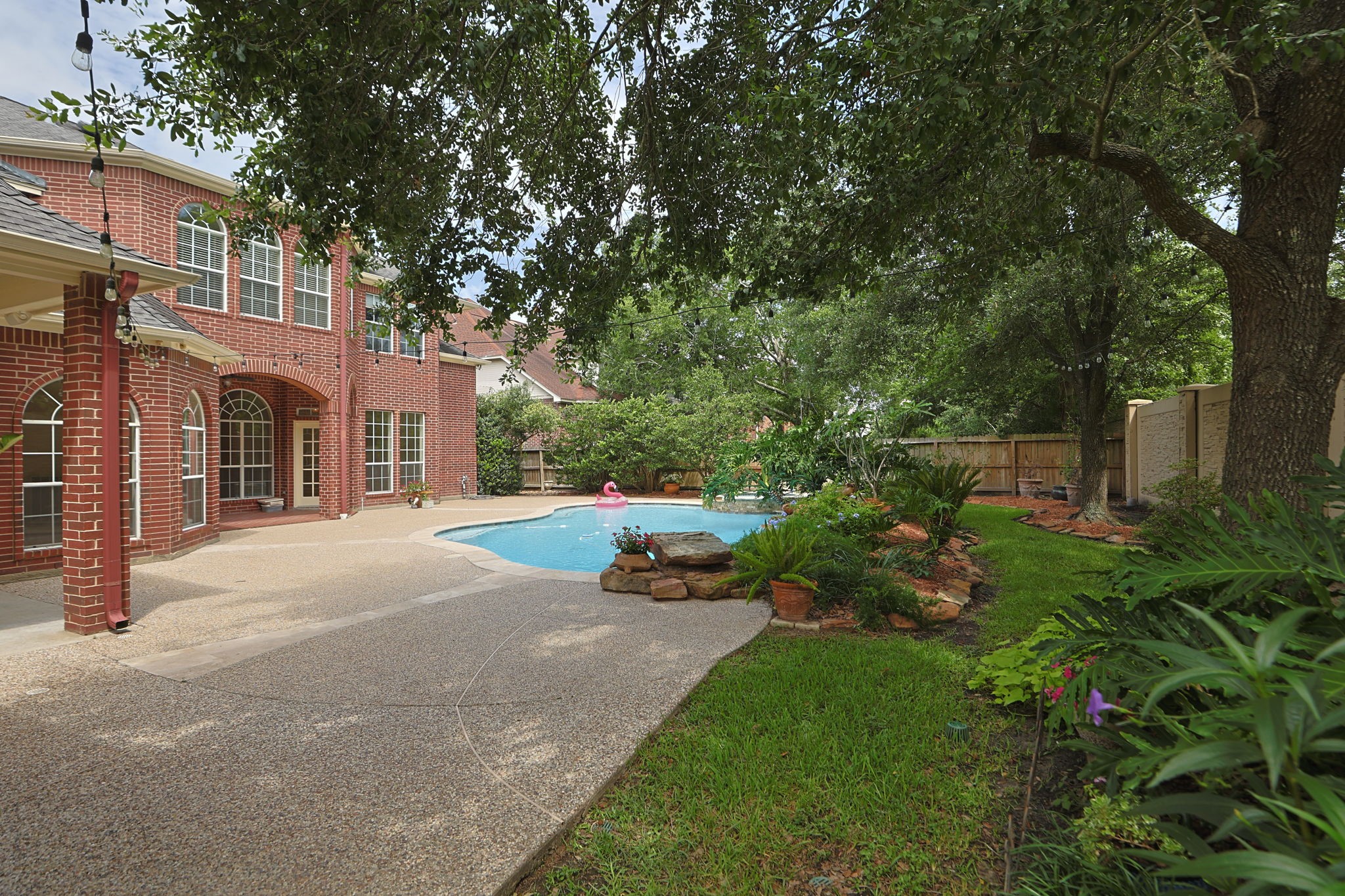 18310 Pamela Way Spring, TX 77379 - Photo 39 of 42 Spacious backyard featuring an extensive pool deck perfect for outdoor lounge furniture and summer entertaining.