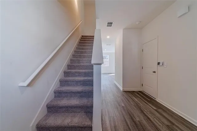 a view of entryway and hall with wooden floor