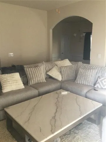 a view of a livingroom with wooden floor and window