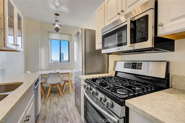 a kitchen with stainless steel appliances granite countertop a stove and a sink