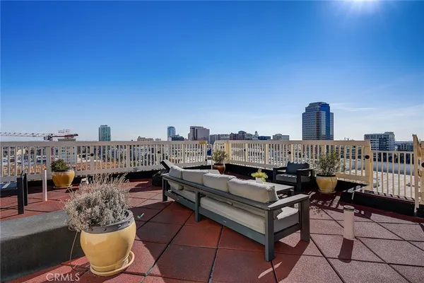 a terrace with outdoor seating and city view