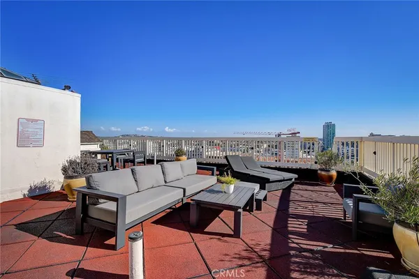 a terrace with outdoor seating and city view