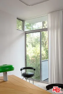 a view of a chair and window in a room