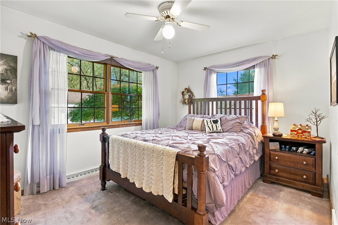 1211 Etter Road Mogadore, OH 44260 - Photo 28 of 48 Carpeted bedroom featuring a ceiling fan with integrated lighting, wood-trimmed windows, and white walls