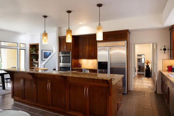a kitchen with granite countertop a sink stainless steel appliances and cabinets