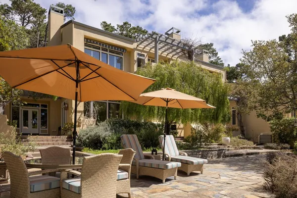 a view of a house with backyard porch and sitting area