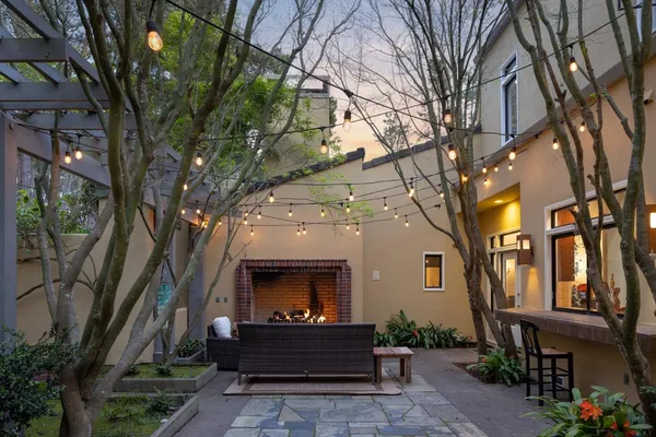 a front view of a house with a tree