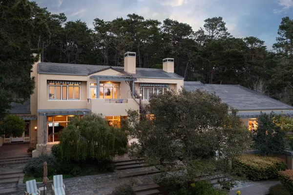 a front view of a house with a garden