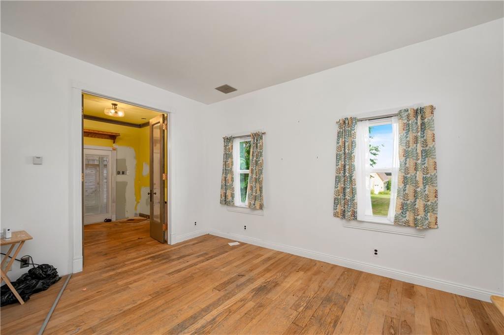 438 Main Street Prospect, PA 16052 - Photo 17 of 46 a view of an empty room with wooden floor and a window