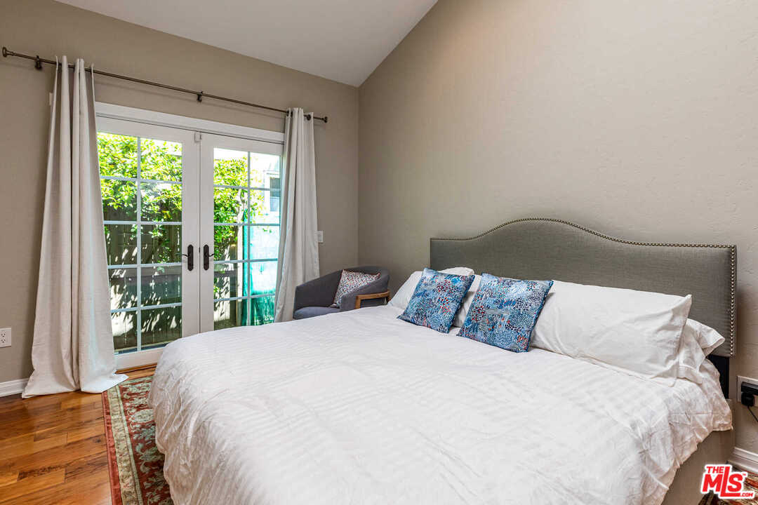 374 East Rustic Road Santa Monica, CA 90402 - Photo 11 of 21 a large bed sitting in a bedroom next to a window