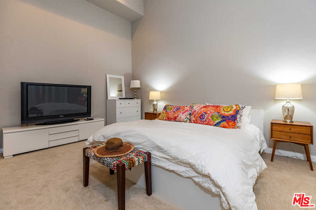 374 East Rustic Road Santa Monica, CA 90402 - Photo 12 of 21 a bedroom with a bed and a flat screen tv