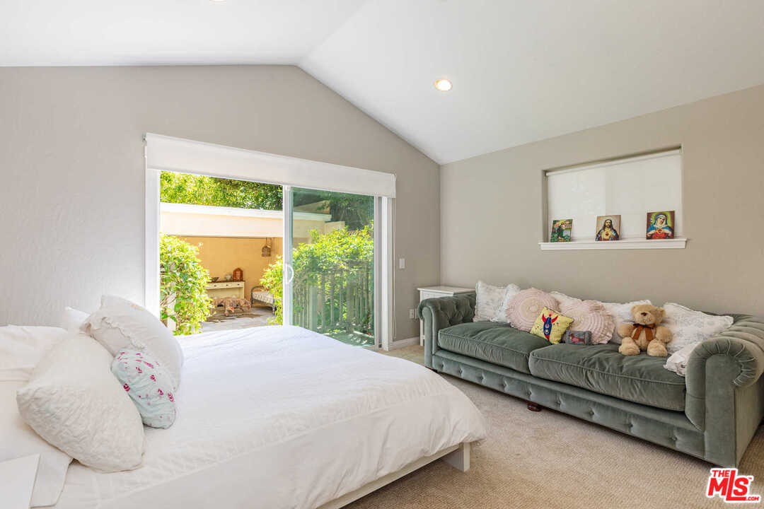 374 East Rustic Road Santa Monica, CA 90402 - Photo 14 of 21 a bedroom with a bed and a couch