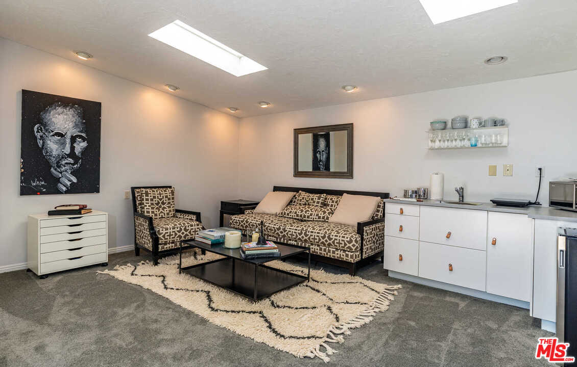 374 East Rustic Road Santa Monica, CA 90402 - Photo 19 of 21 a living room with furniture and paintings on the wall