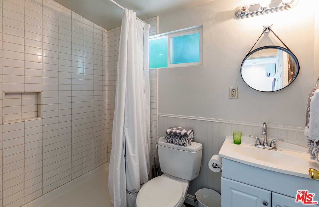 374 East Rustic Road Santa Monica, CA 90402 - Photo 21 of 21 a white toilet sitting next to a bathroom sink