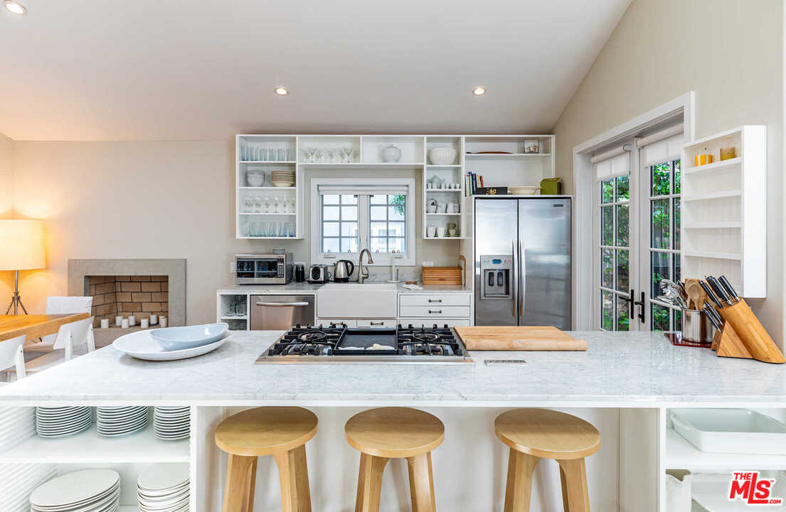 374 East Rustic Road Santa Monica, CA 90402 - Photo 7 of 21 a kitchen with a counter top space appliances and windows