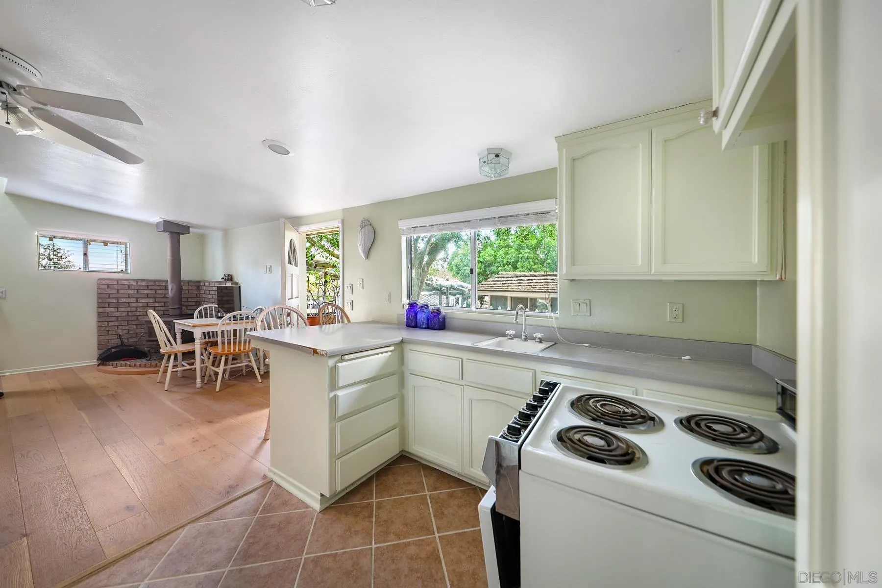 13764 McNally Road Valley Center, CA 92082 - Photo 15 of 26 a kitchen with a stove a sink and a refrigerator