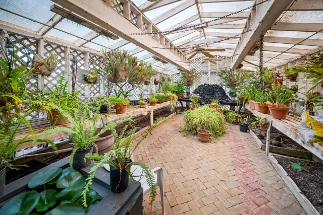 a view of a house with porch and garden