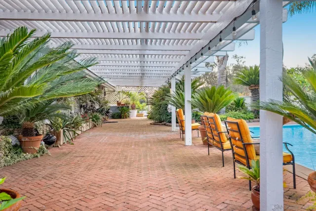 a backyard of a house with barbeque oven table and chairs