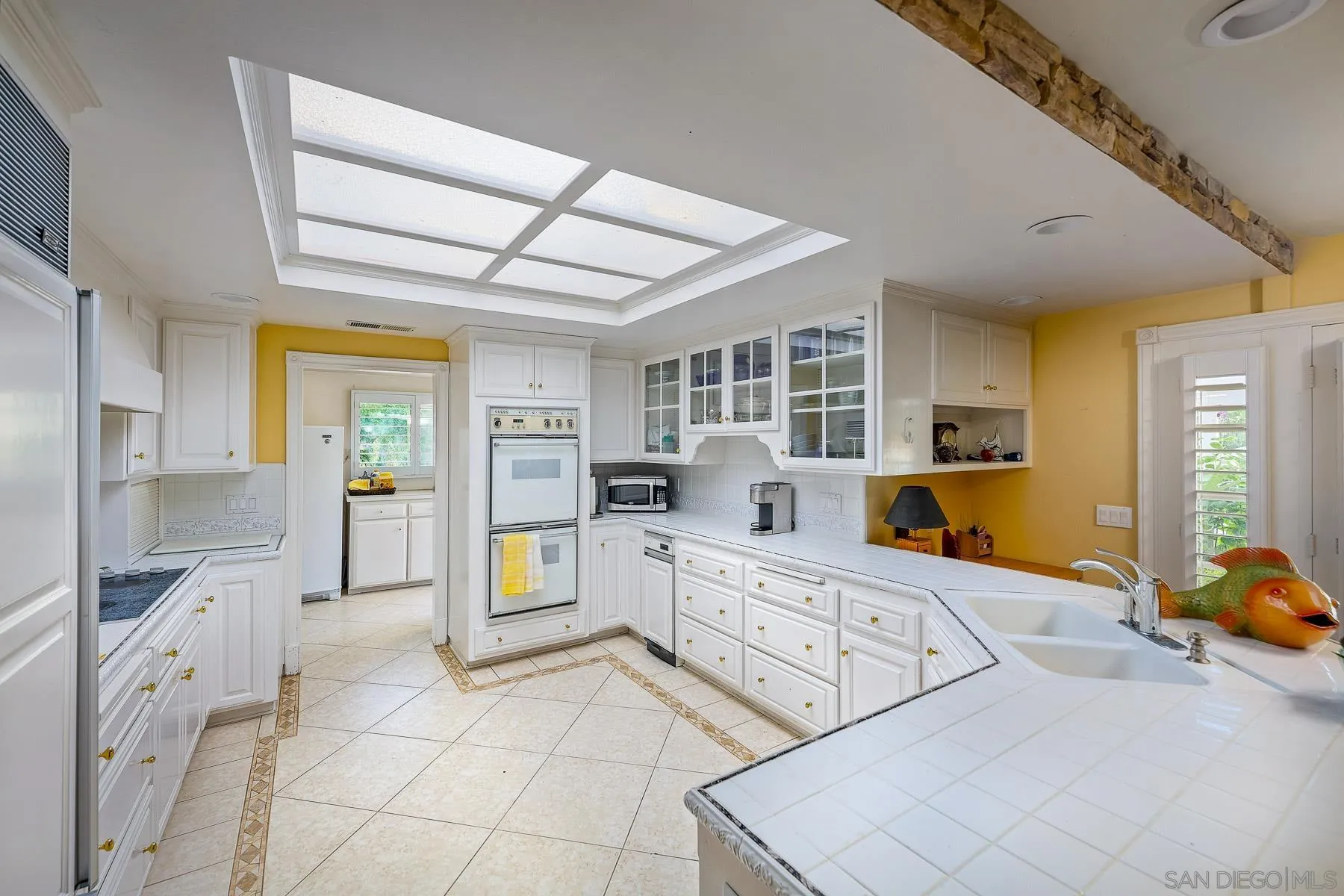 13764 McNally Road Valley Center, CA 92082 - Photo 3 of 26 a large white kitchen with cabinets