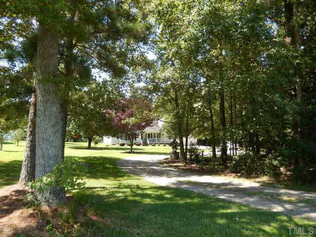 3151 Sanders Road Willow Spring, NC 27592 - Photo 2 of 24 a view of a park with large trees