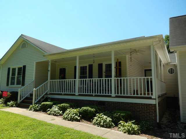 3151 Sanders Road Willow Spring, NC 27592 - Photo 3 of 24 a view of a house with wooden fence and garden