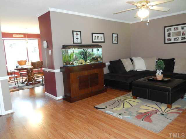 3151 Sanders Road Willow Spring, NC 27592 - Photo 6 of 24 a living room with furniture and a flat screen tv