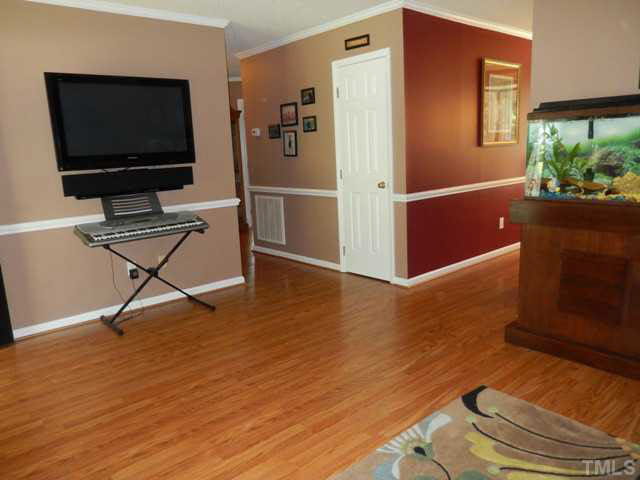 3151 Sanders Road Willow Spring, NC 27592 - Photo 7 of 24 a living room with furniture and a flat screen tv