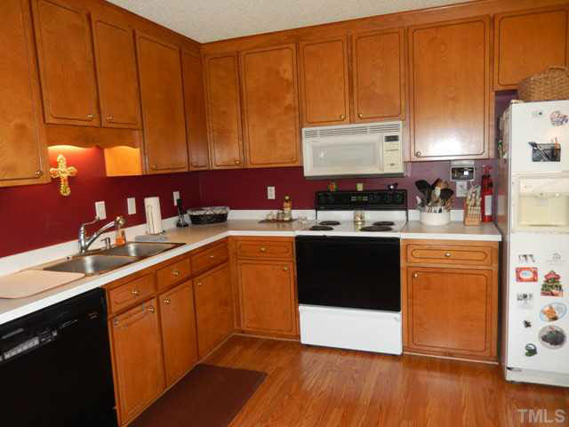 3151 Sanders Road Willow Spring, NC 27592 - Photo 10 of 24 a kitchen with a sink a stove and cabinets