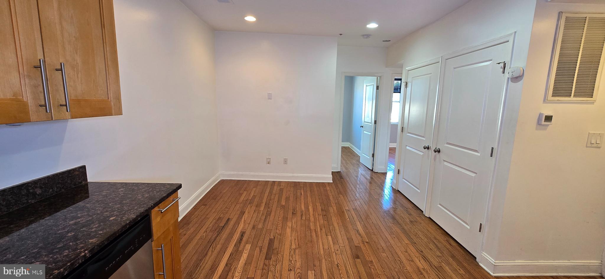 1835 Benning Road Northeast, Unit 1 Washington, DC 20002 - Photo 2 of 12 a view of a hallway with wooden floor and staircase