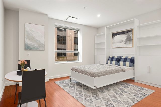 a living room with a bed and furniture