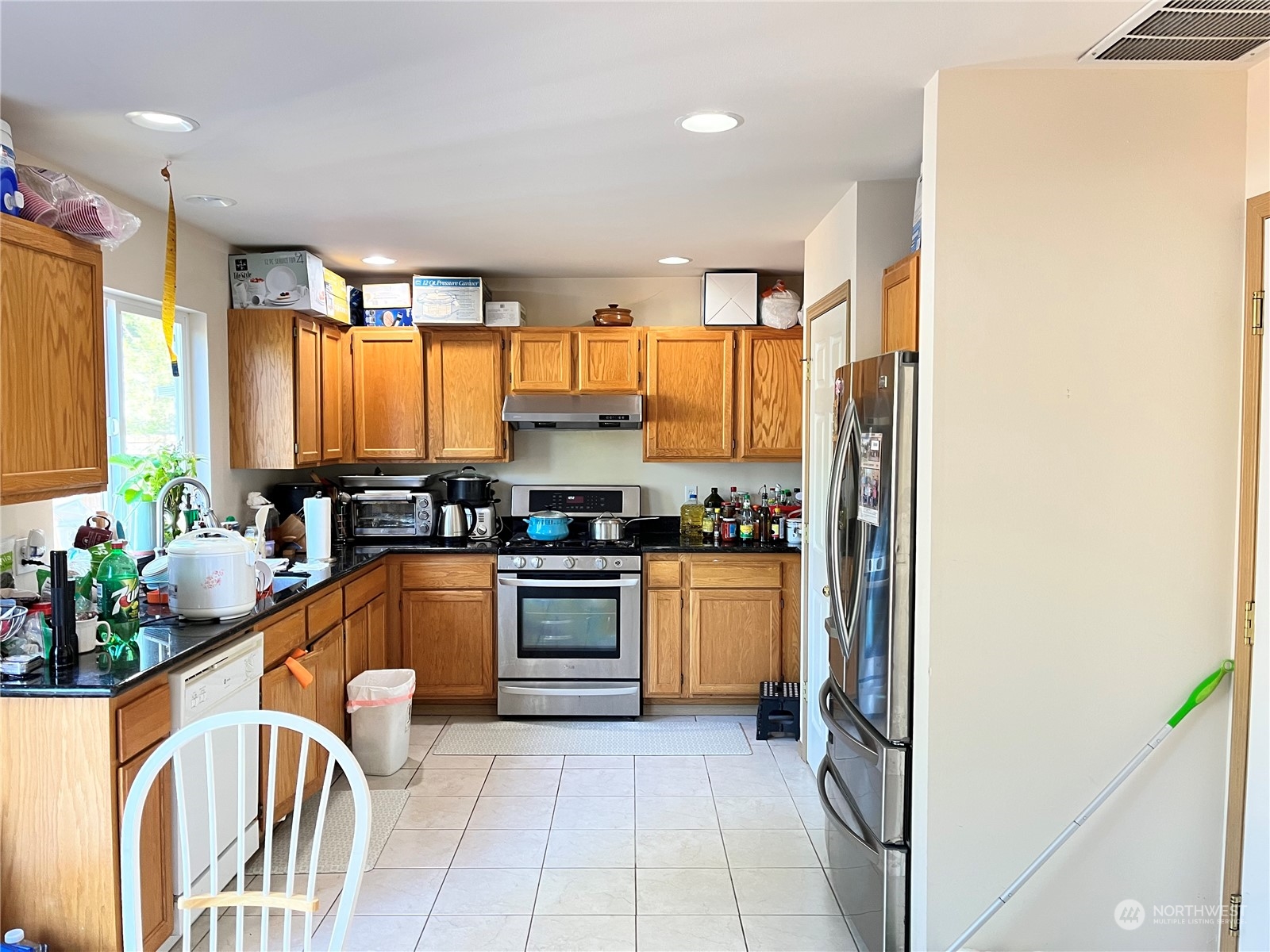 121 167th Street Southwest Bothell, WA 98012 - Photo 3 of 17 a kitchen with stainless steel appliances granite countertop a stove a sink and a refrigerator
