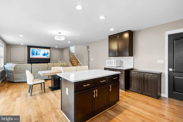 a kitchen with a sink cabinets and wooden floor