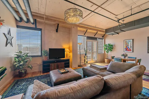 a living room with furniture and a chandelier