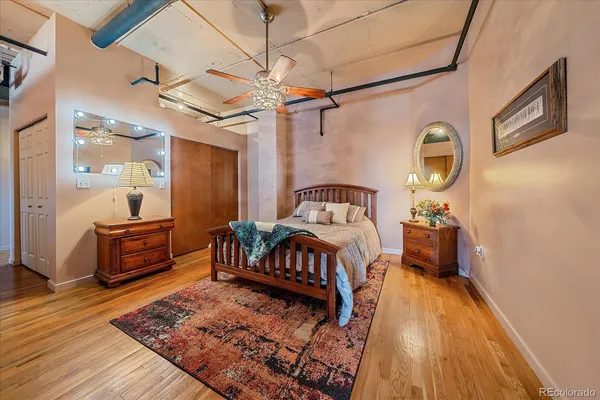 a bedroom with a bed and wooden floor