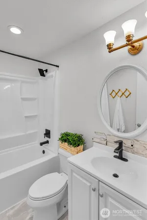 a bathroom with a sink mirror vanity and toilet