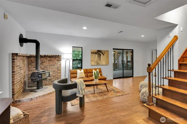 a living room with furniture and wooden floor