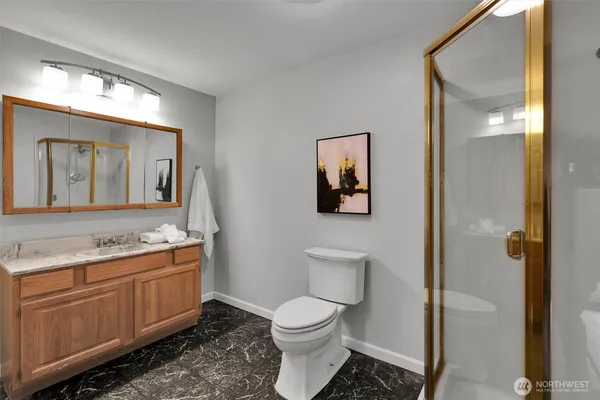 a spacious bathroom with a toilet sink and mirror