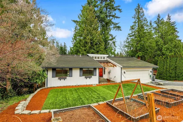 a view of a house with pool and a yard