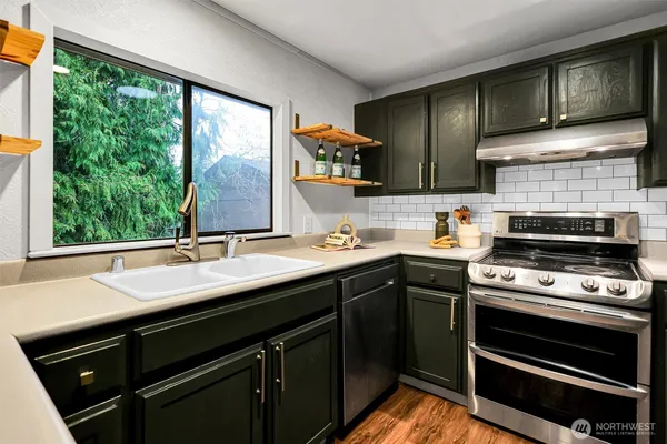 a kitchen with a sink stove and cabinets
