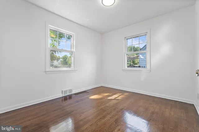 a view of a room with wooden floor and entryway