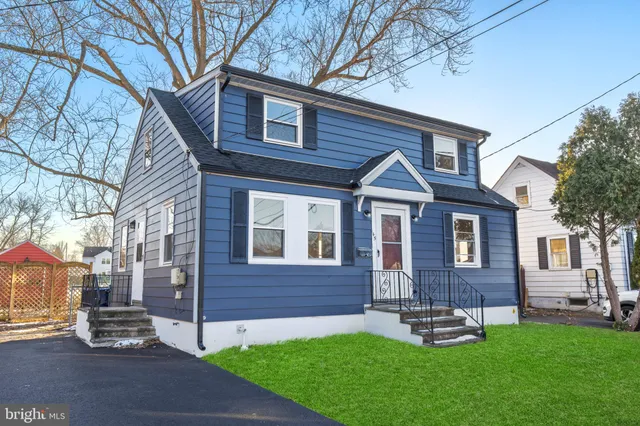 a front view of a house with a yard and green space