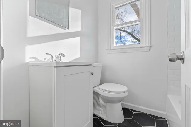 a white toilet sitting next to a bathroom sink