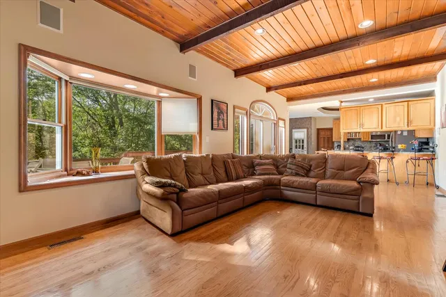 a view of a workspace with furniture and a window